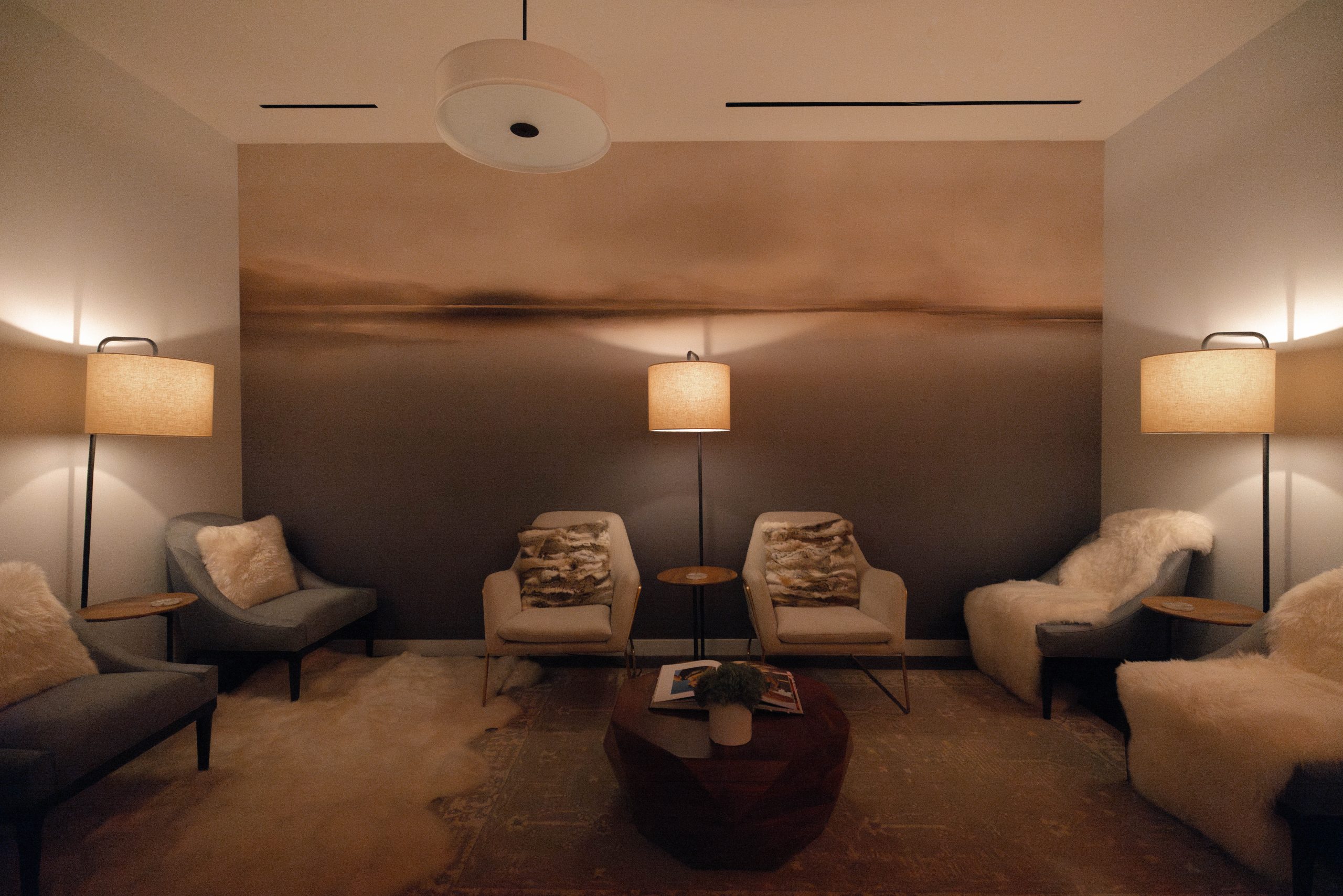Tranquil spa lounge at Exhale Spa, featuring cozy seating, soft lighting, and a calming atmosphere, ideal for relaxation and wellness.