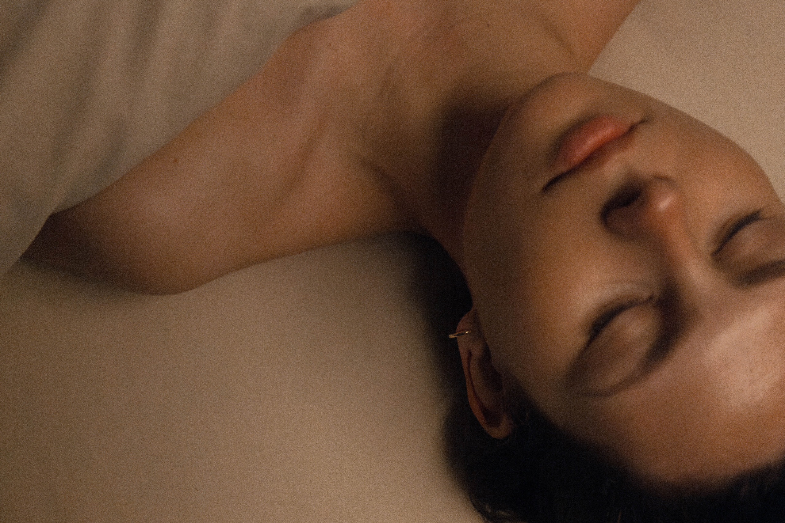 Woman relaxing during a spa treatment, eyes closed, showcasing tranquility and wellness at Exhale Spa, Central Park.