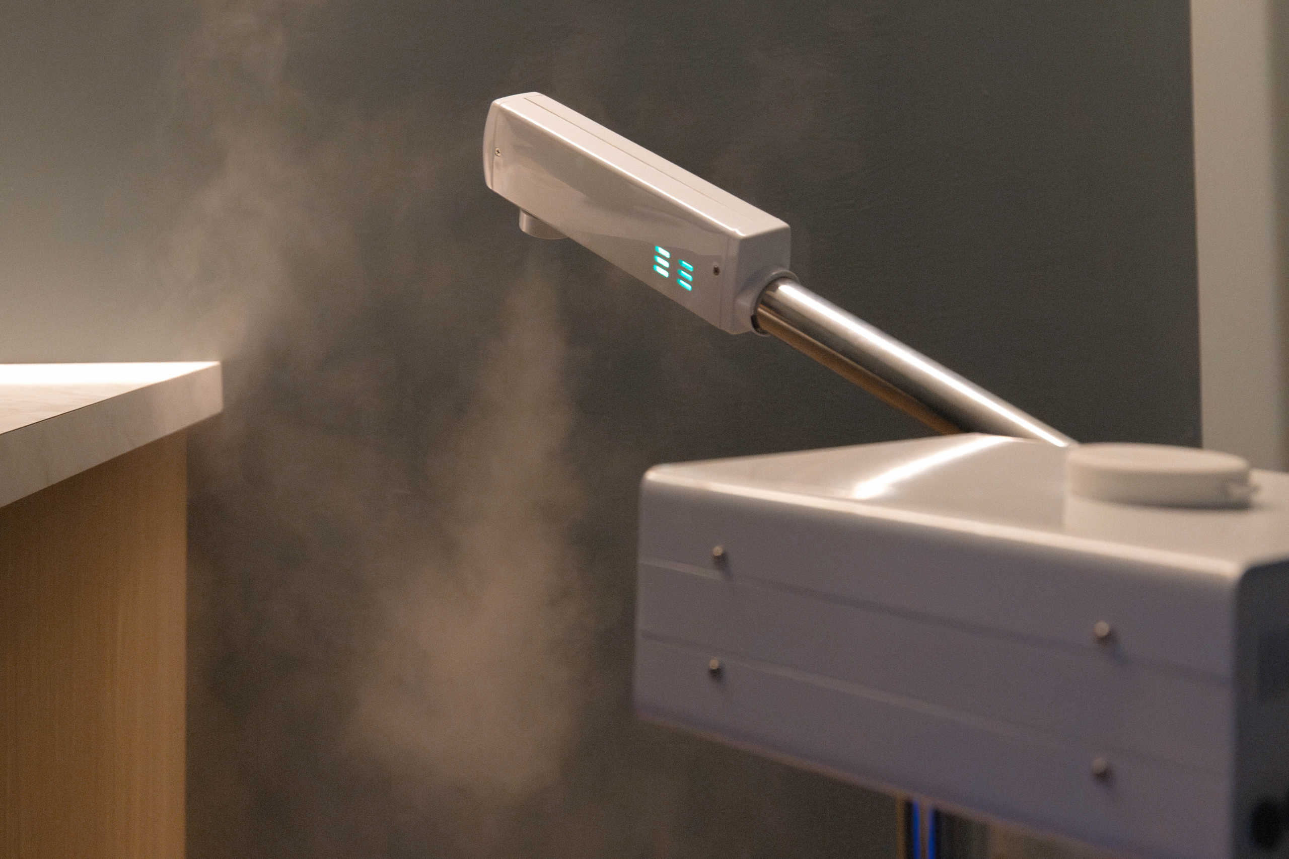 Steam facial device emitting mist in a tranquil spa setting, highlighting wellness and skincare treatments at Exhale Spa, Thompson Central Park.